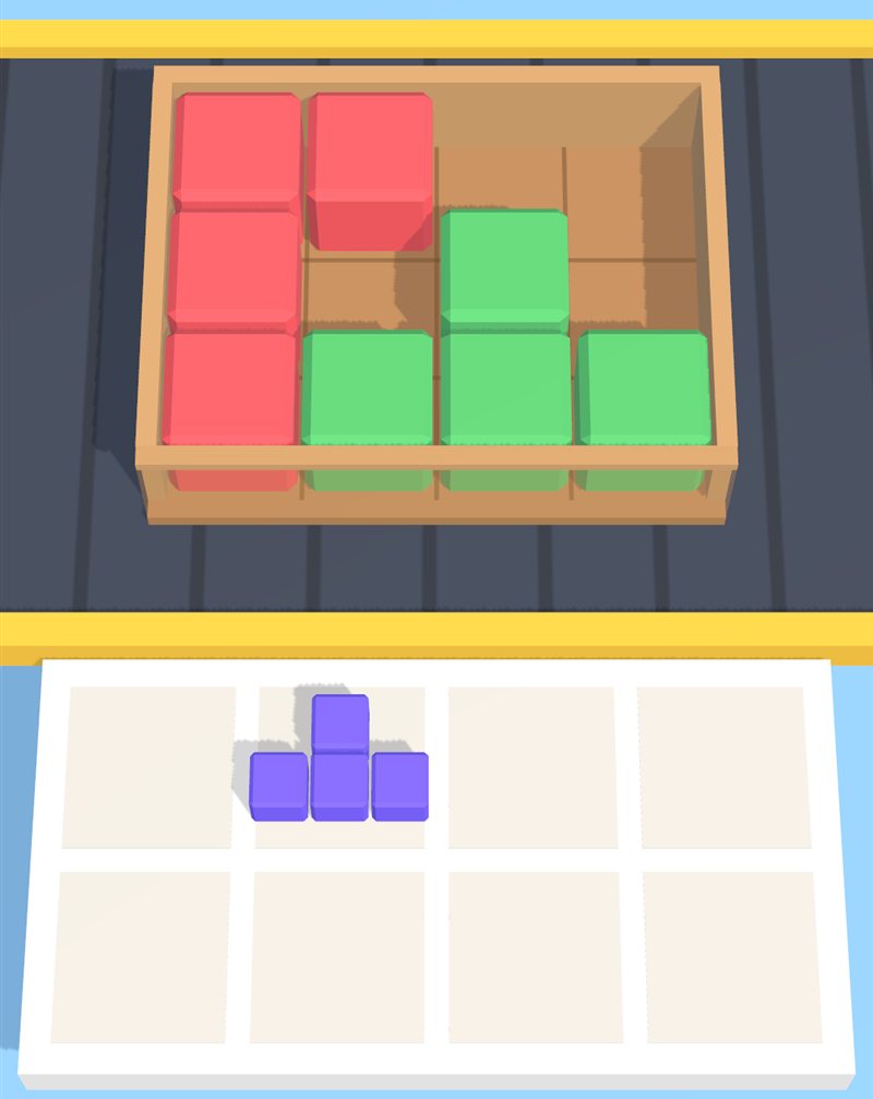 An open cardboard box on a conveyor belt, half filled with red and green blocks, with a purple piece waiting in the tray below.